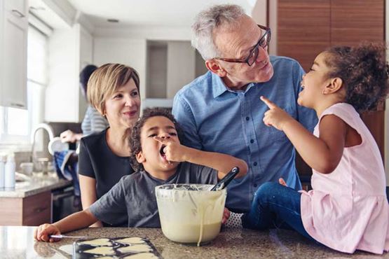 Mixed race family having fun and baking in the kitchen